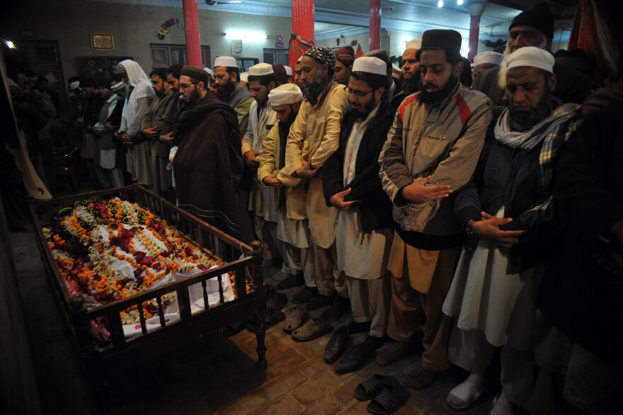 Pakistani mourners pray during the funeral of a student killed in the attack.