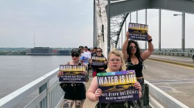 Advocates march over the Centennial Bridge, which connects Illinois and Iowa in the Quad Cities, on May 13, 2023. They called for the Mississippi River to be granted legal rights.