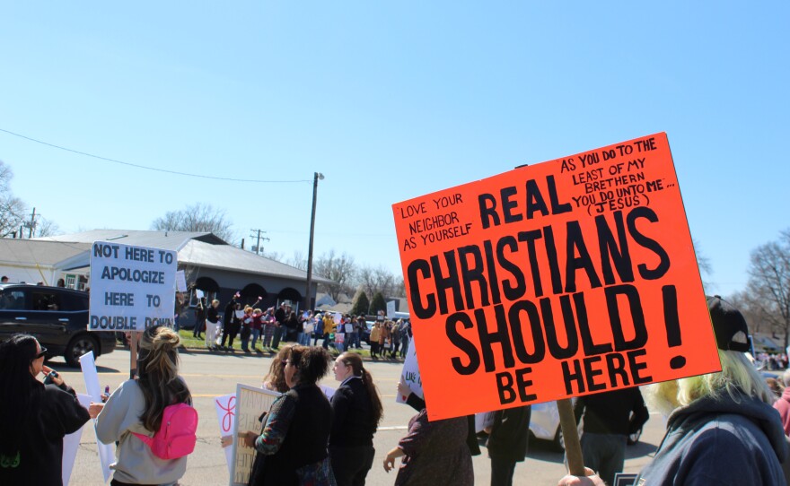 A sign reads "Real Christians Should Be Here." At the "No Kings" protest in Peoria.