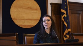 a woman sits at a desk