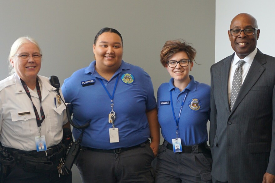 St. Louis police cadets Cearra Flowers (center left) and Mary Mazzola (center right)