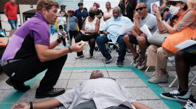 Shaun Willis, with the Brooklyn Community Recovery Center, demonstrates how to use Narcan to revive a person in the case of a drug overdose in New York City. 