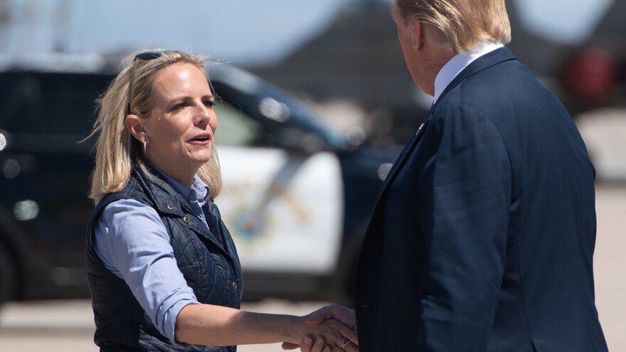 Secretary of Homeland Security Kirstjen Nielsen shakes hands with President Trump in El Centro, Calif., on April 5 after he arrived to visit the border wall between the United States and Mexico. [Saul Loeb / AFP / Getty Images]