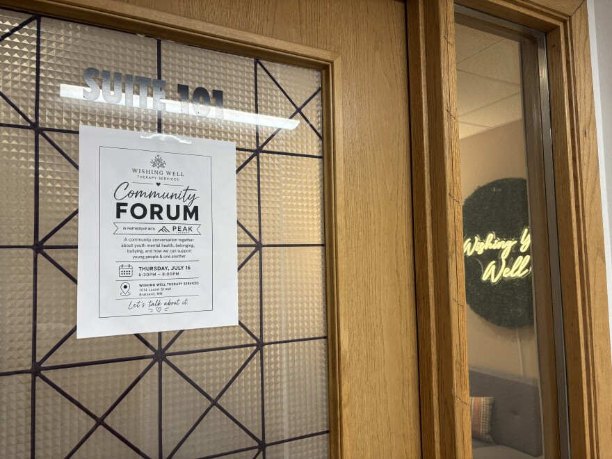 A sign for the community forum on the door of Wishing Well Therapy Services on July 16, 2026, in Brainerd.