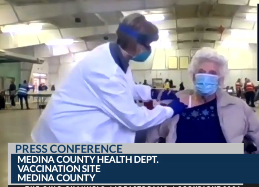 A public health nurse in Medina County administers vaccine to a woman over age 70 during Gov. Mike DeWine's coronavirus briefing Thursday. 