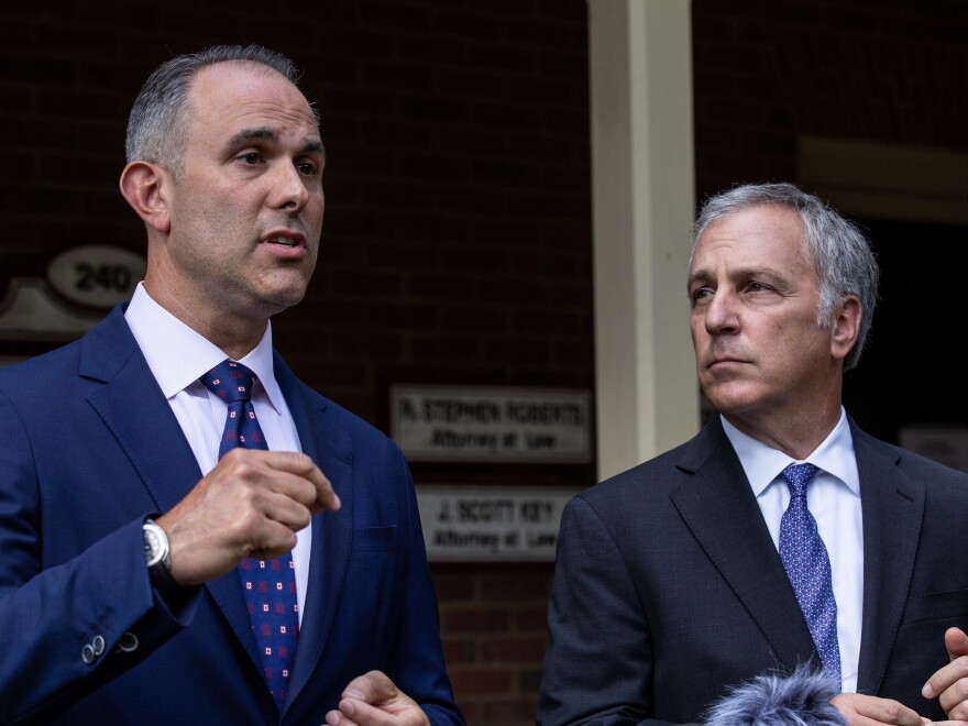 Attorney Jason Sheffield. left, and his law firm partner, Robert Rubin, respond to questions from the press outside their office on Thursday, in Decatur, Ga. The attorneys are representing Travis McMichael.
