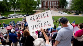 Ann Hayles, of Raymore, Mo., rallies alongside hundreds in support of voter-backed initiatives legalizing abortion and guaranteeing paid sick leave at the Capitol on Thursday.