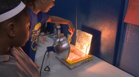Seventh graders Tamyah Conner (left) and Bella Rollins (right) of Center for Inquiry School 27 in Indianapolis made a solar oven for the school's climate fair in March.