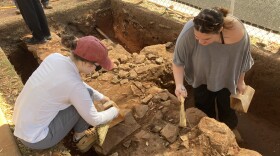 University of Alabama student archeologists carefully dig at the site of Washington Hall student dormitory