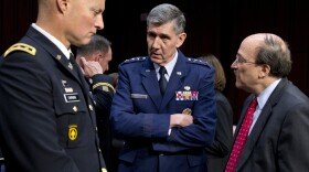 Lt. Gen. Richard Harding, Air Force judge advocate general, center, speaks with Army Lt. Gen. Dana Chipman, left, and Robert Taylor, acting general counsel of the Defense Department, prior to testifying before the Senate subcommittee on sexual assault on March 13.