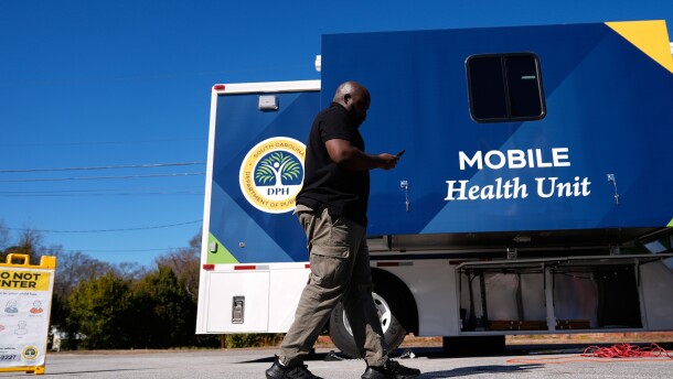 Jared Charles, a community engagement worker with the South Carolina Department of Public Health, walks outside of a mobile clinic in Inman, S.C, Friday, Feb. 13, 2026. (AP Photo/Erik Verduzco)