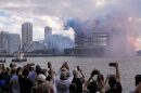 People watch pyrotechnics just before the controlled implosion of the former Mandarin Oriental Hotel on Brickell Key, Sunday, April 12, 2026, in Miami.