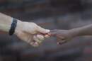 Frank Martin Gill holds hands with his foster son, known as N.R.G. (Joe Raedle/Getty Images)