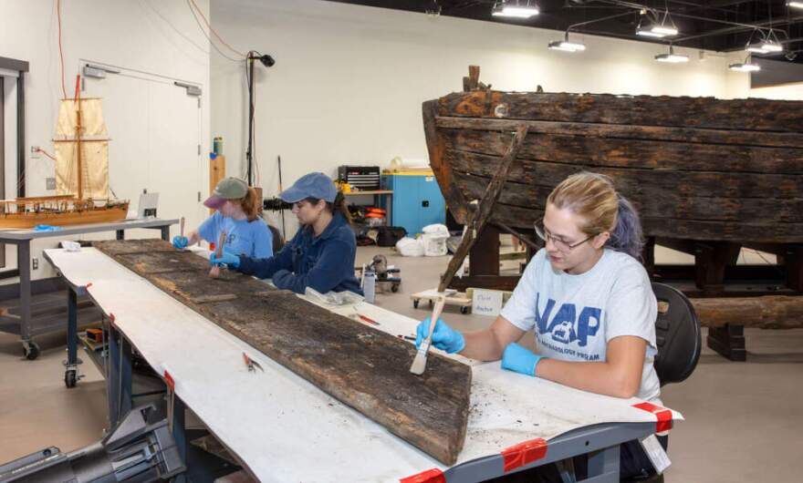 Conservators
from Texas A&M's  Center for Nautical Archeology, Conservation
Research Lab
working on the
gunboat Philadelphia. (Courtesy of the Smithsonian Institution)