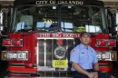 Man sits down next to fire truck.