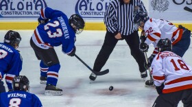 Police Officers and Fire Fighters face-off while playing the benefit hockey game