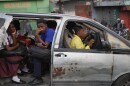 Passengers ride in a shared taxi as it makes its way through Port-au-Prince, Haiti, Wednesday, March 25, 2026.