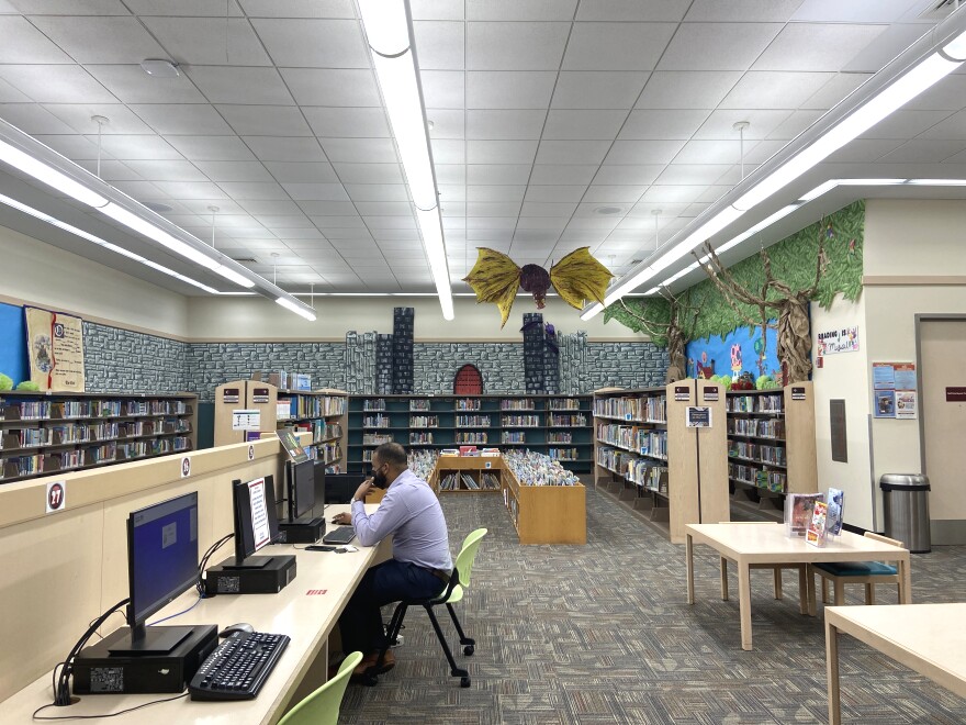 The children's section of the Sunrise Dan Pearl Branch Library includes a papier-mâché dragon and books on science fair project ideas available for checkout.