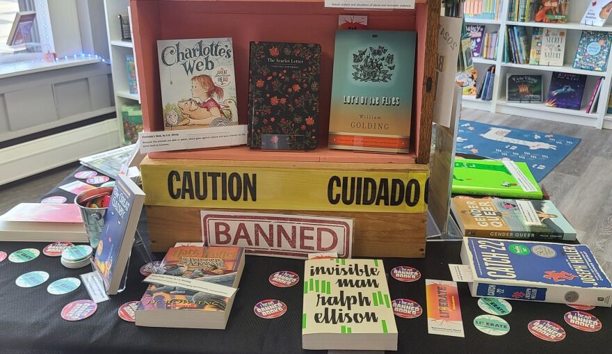 A display shows books that have been banned like Charlotte's Web, Harry Potter, Catch-22 and more.