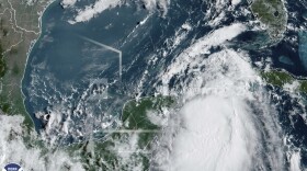 In this Monday, Aug. 28, 2023, 9:41 am ET satellite image provided by the National Oceanic and Atmospheric Administration, Tropical Storm Idalia moves between Mexico's Yucatan peninsula, left, and Cuba, right. Idalia intensified early Monday and was expected to become a major hurricane before it reaches Florida's Gulf coast, according to the National Hurricane Center. (NOAA via AP)
