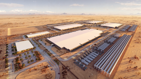 Digital rendering of a data center campus in the desert. There are several huge buildings and rows of smaller buildings and infrastructure.