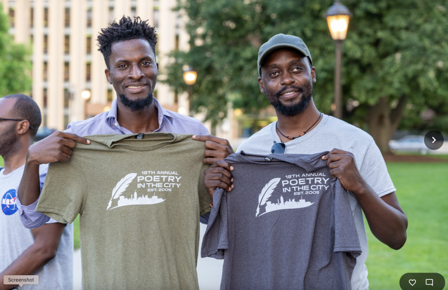 two men on the State Capitol lawn holding up Poetry in the City shirts to their chests