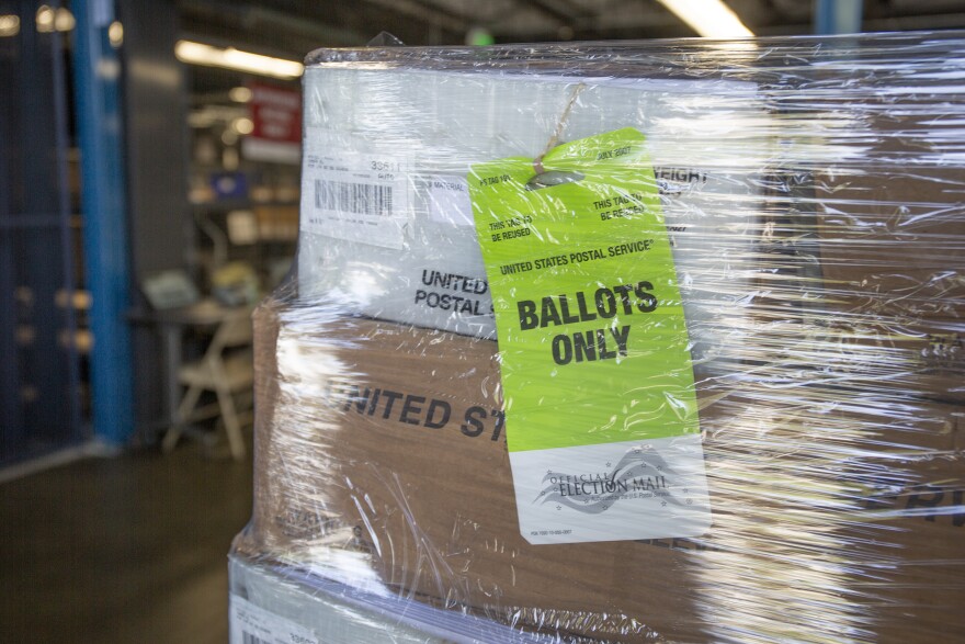 Boxes of ballots wrapped in plastic on a pallet