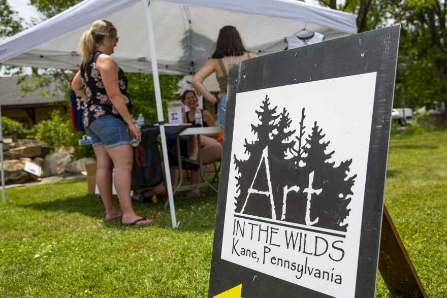 A poster welcomes visitors to Art in the Wilds in Kane, Pennsylvania