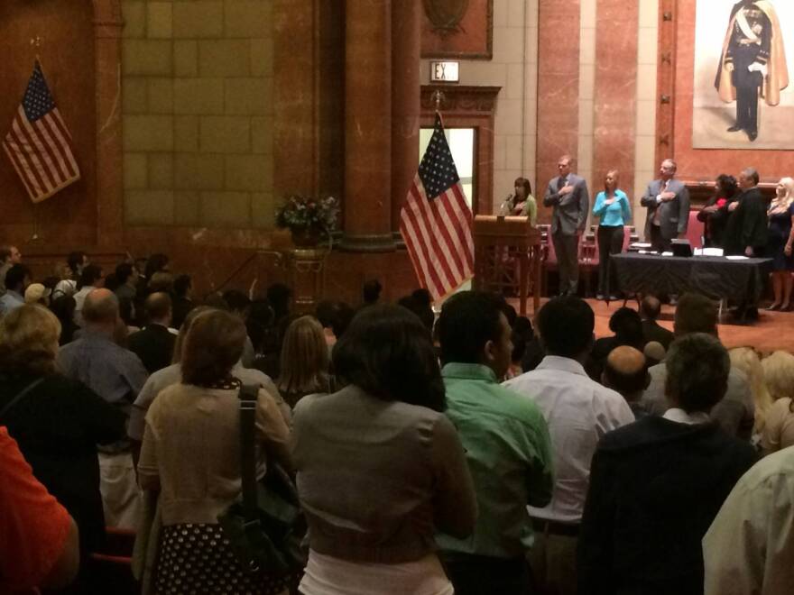Local dignitaries, 96 immigrants, and their families pledged allegiance to the American flag.