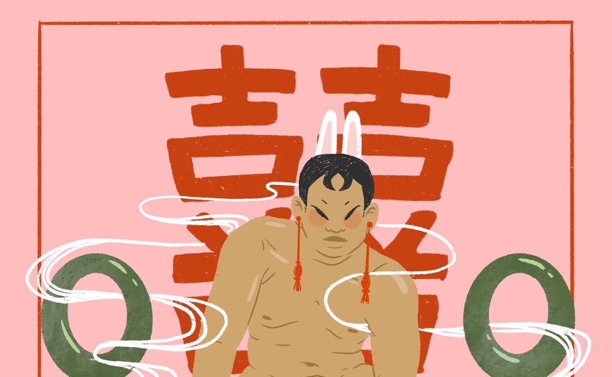 A trans man who is naked sits on a giant peach with white lilies in his hand. Two jade rings are on either side of him and the character for double happiness is painted in red against the pink background.