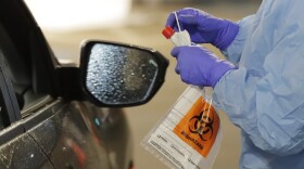 A nurse at a drive up COVID-19 coronavirus testing station, set up by the University of Washington Medical Center, on Friday, March 13, in Seattle. (Ted S. Warren/AP)