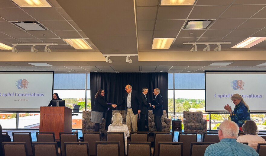 Former politicians Chet Edwards, David Sibley and Van Taylor shake hands after a two hour discussion about American politics.