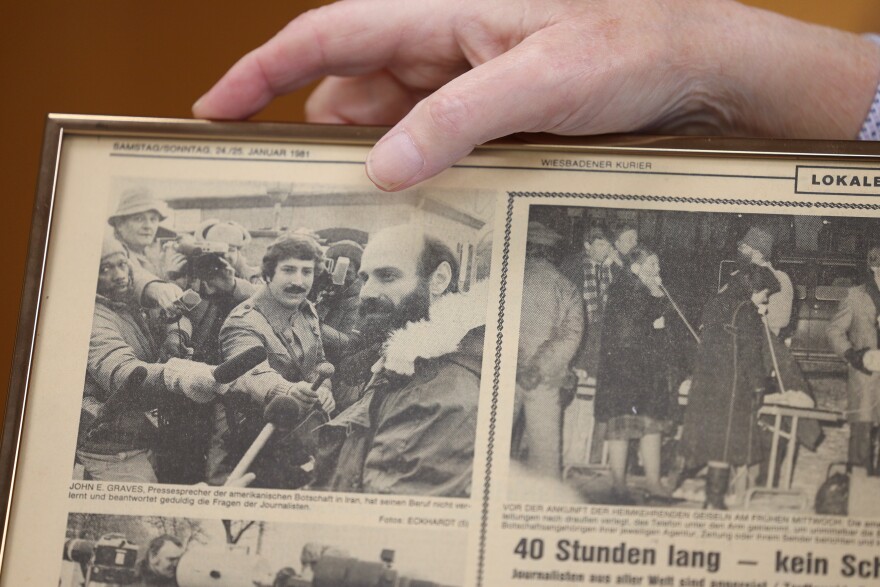 Norm Silverstein, President & CEO of WXXI Public Media, holds a framed page from a German news paper with a photo of him as a young radio reporter covering the release of the Iranian Hostages at Ramstein Air Base in 1981. Silverstein has over seen WXXI, one of New York's leading public television, radio and online educational institutions for 28 years. (photo by Max Schulte)