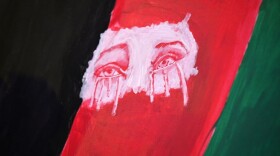 Tearful eyes are seen painted on a flag as members of the Los Angeles Afghan community and their supporters hold a vigil for Afghanistan outside the West LA Federal Building in Los Angeles, Aug. 17, 2021. (Robyn Beck/AFP/Getty Images)