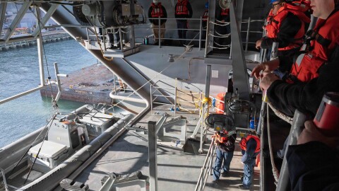Sailors assigned to Pre-Commissioning Unit of John F. Kennedy lower a rigid-hull inflatable boat.