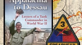 This photo shows the cover of the book "Appalachia to Dessau:  Letters of a Tank Commander in World War II" with John Goodin posing on the side of a military vehicle.