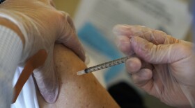A senior citizen receives the Pfizer-BioNTech COVID-19 vaccine at the The Palace assisted living facility, Tuesday, Jan. 12, 2021, in Coral Gables, Fla.