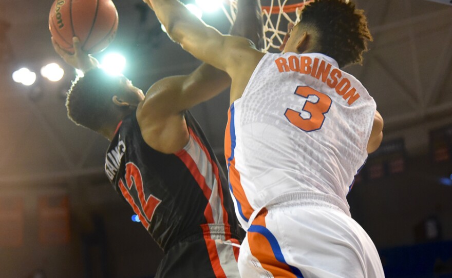 Georgia's Kenny Gaines (12) has his shot blocked by Florida's Devin Robinson (3) in the first half. (Greenberry Taylor/WUFT News)