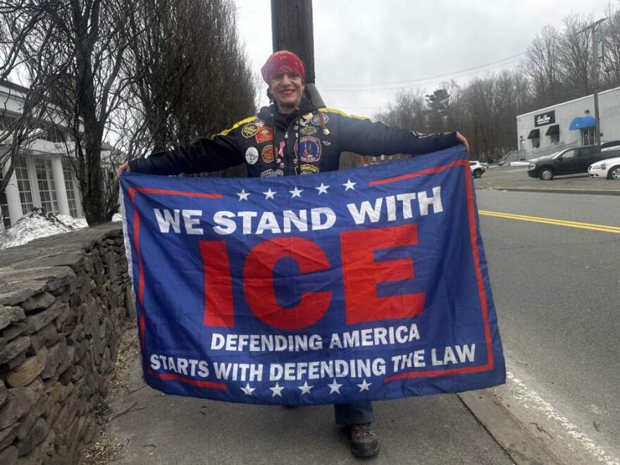 Counterprotester Laura Simpson stands in front of Cafe Escadrille in Burlington. (Simón Rios/WBUR)