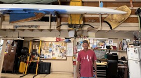 Retired lifeguard Mark Dombroski stands under the initial three tow-in pull systems created.