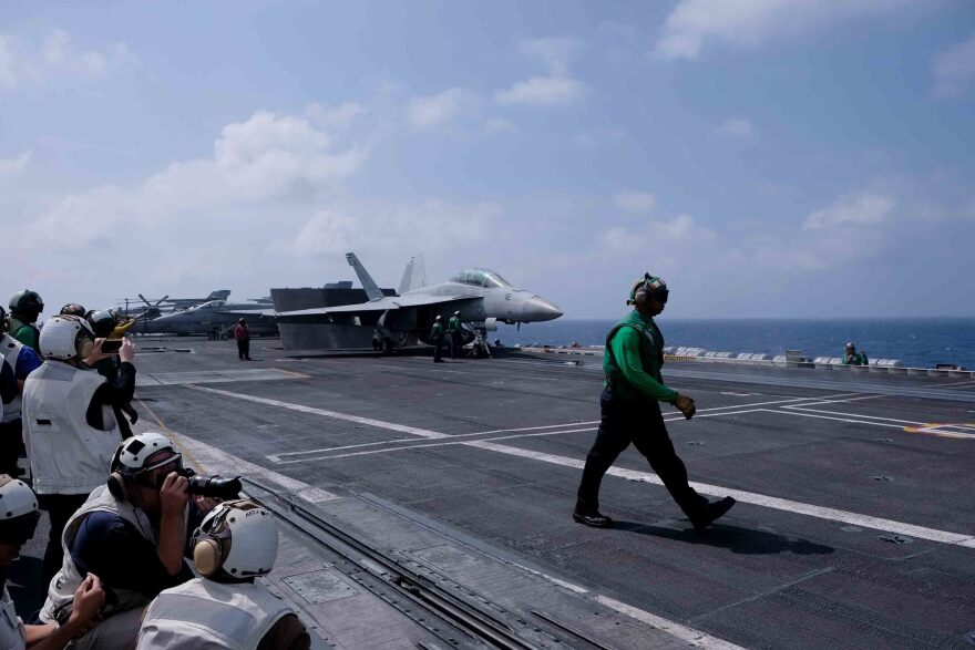 A Navy fighter jet prepares to take off from the deck of the aircraft carrier USS Carl Vinson in the South China Sea. The carrier is on its second extended deployment in the Western Pacific in two years.