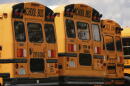 School buses are lined up in a storage lot, Thursday, Aug. 14, 2025, in Manchester, New Hampshire. (Charles Krupa/AP)