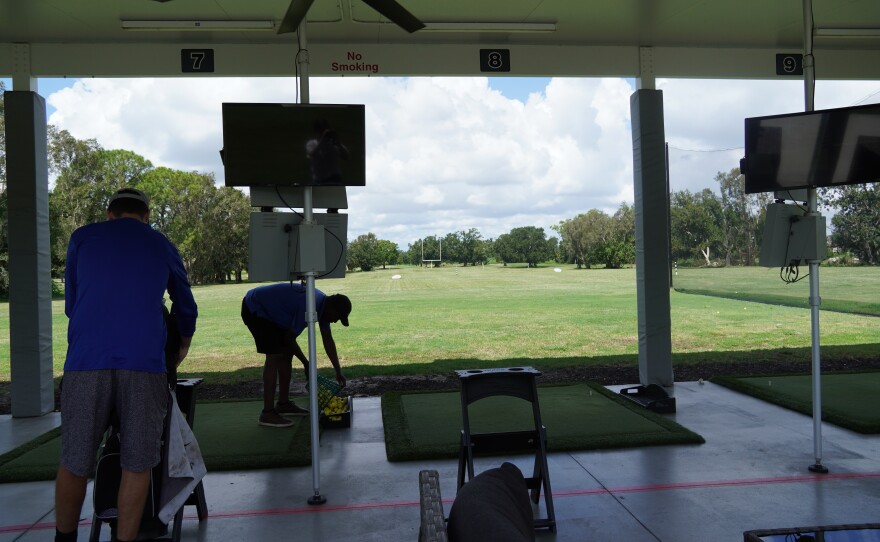 A picture of a driving range at a golf course 