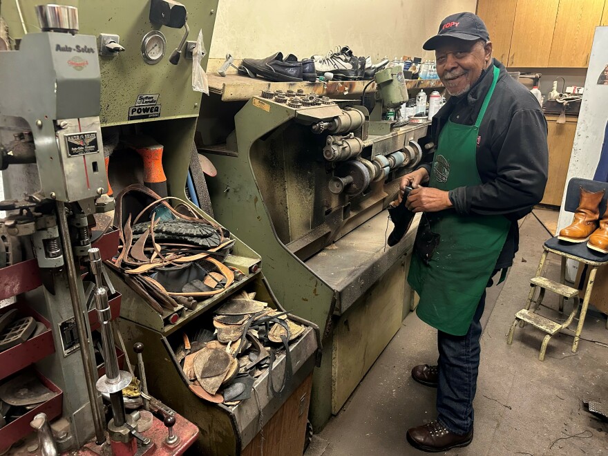 Cobbler James Wallace Sears smooths down the sole of a shoe at the repair shop his father opened in 1973.