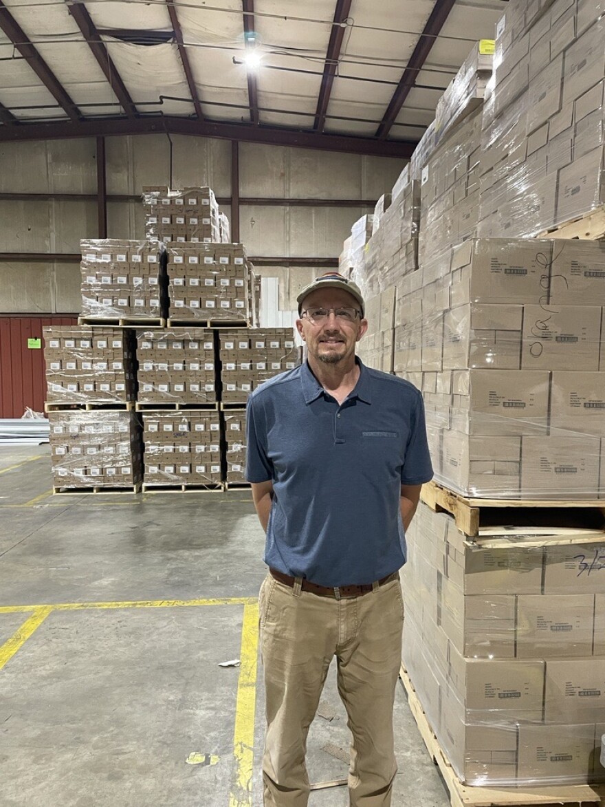 Mountain CORE Mission's Gary Smith poses at the nonprofit's warehouse in Sylva.