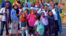 Hani Ali stands amid a group of children whom are a part of her mentorship program.