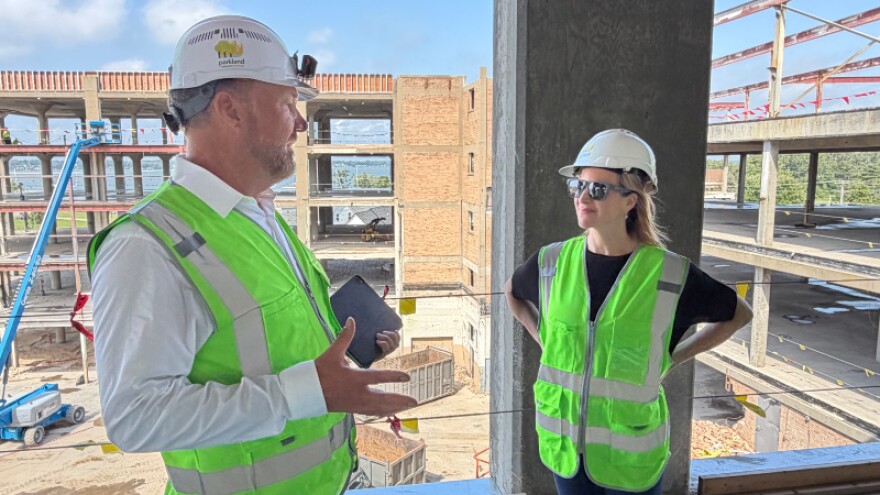 Secretary of State Jocelyn Benson tours a housing construction site in Muskegon.
