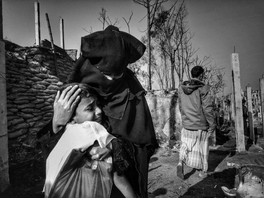 A mother and son are reunited the day after being separated during a fire in the camp.