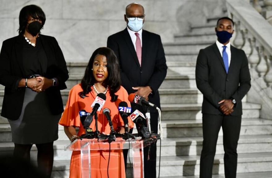 St. Louis Mayor-elect Tishaura Jones addresses the media in April 2021 inside City Hall with new appointees, retired police sergeant Heather Taylor (left) named senior advisor to the director of public safety, Dan Isom (center) named interim public safety director and the new Treasurer Adam Layne.