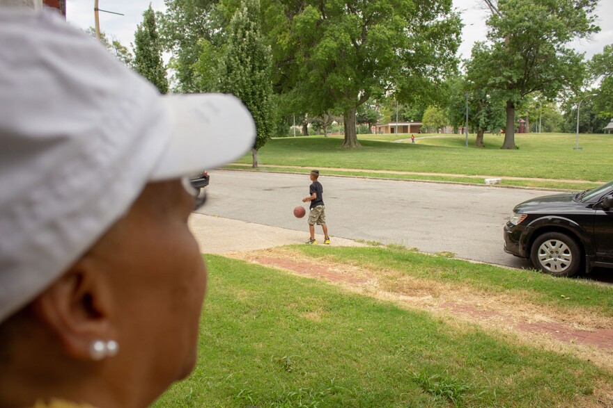 Madison sitting in front of her daughter's house, watching her grandson play.